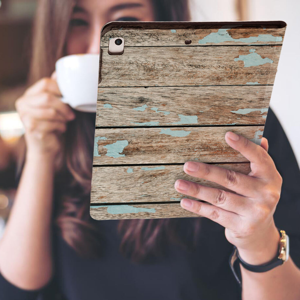 a girl is holding and viewing personalized iPad folio case with Wood design