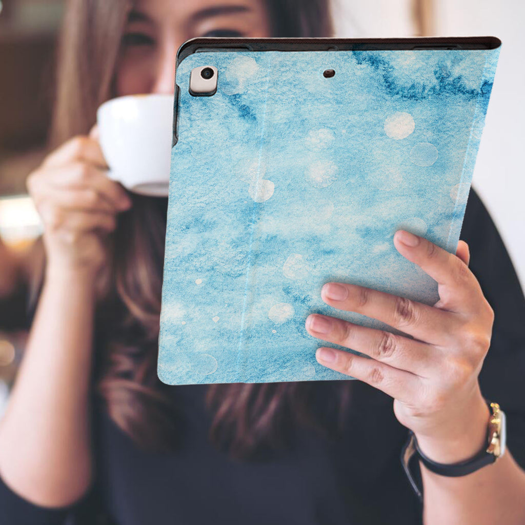 a girl is holding and viewing personalized iPad folio case with Winter design