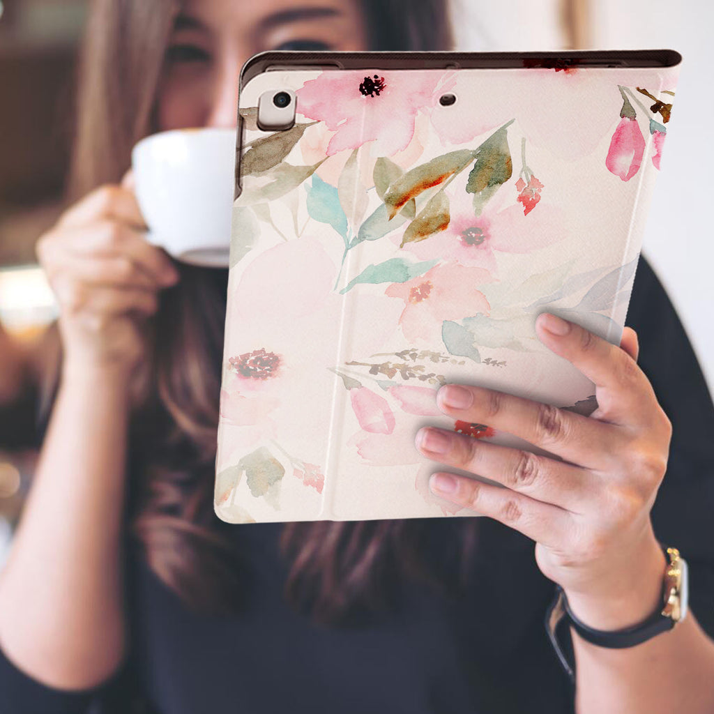 a girl is holding and viewing personalized iPad folio case with Flamingo design